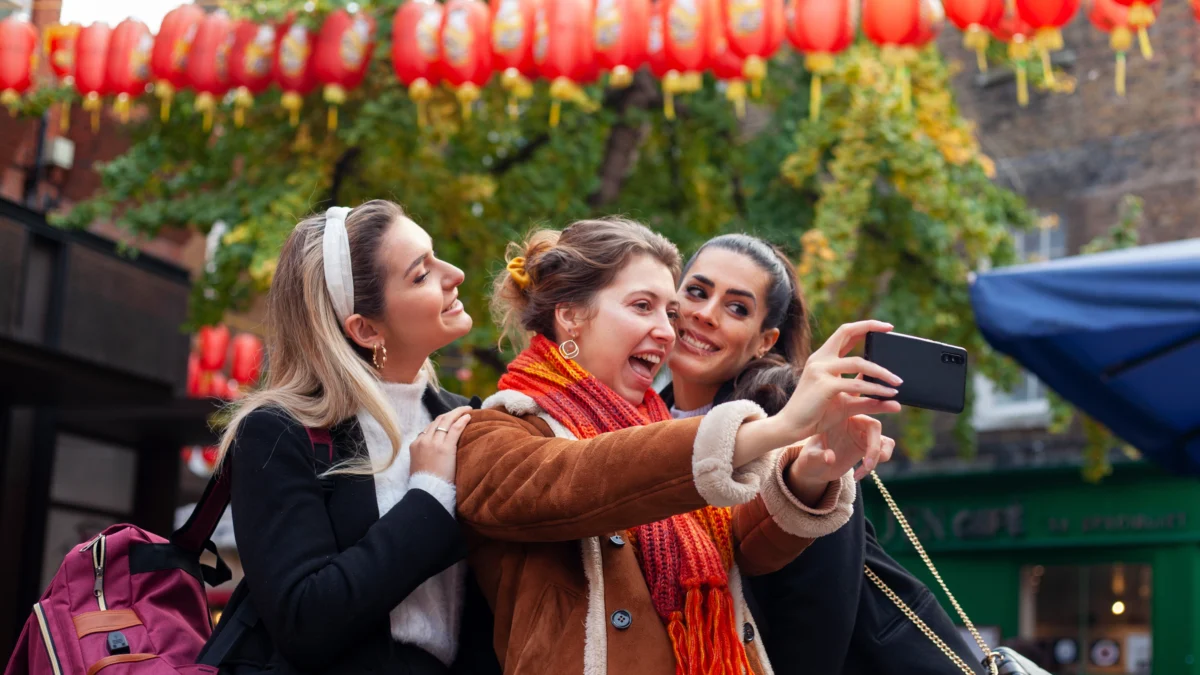 alt=" beautiful-friends-spending-quality-time-together,happy young woman feeding pigeons Best Travel Agency '