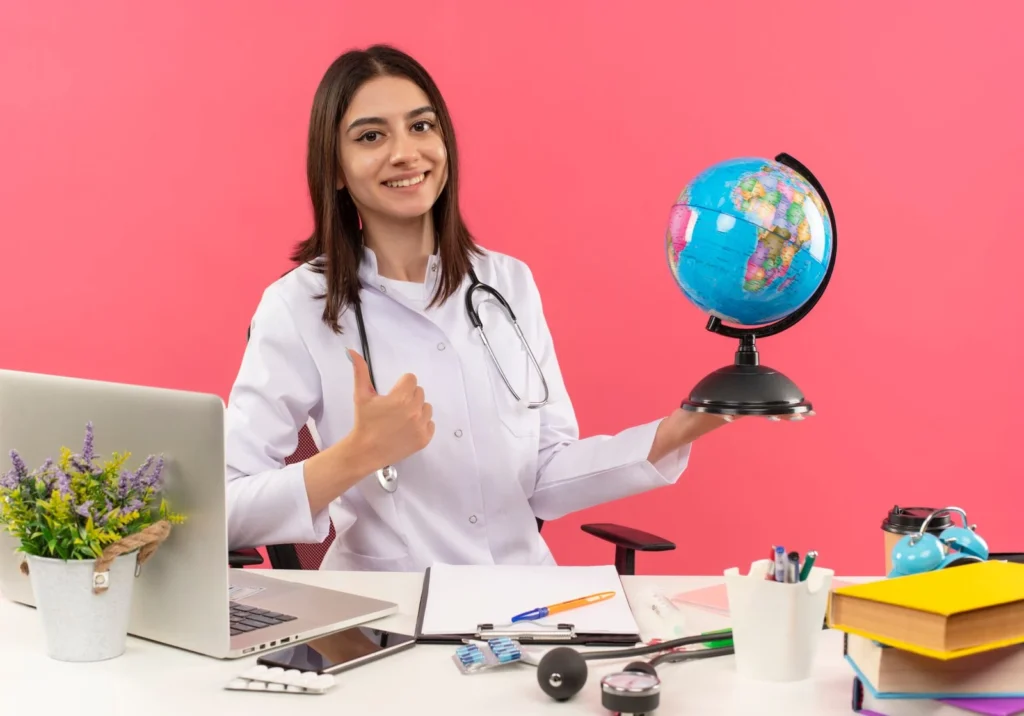 alt=*Study MBBS in Central Americayoung woman doctor in white coat with stethoscope and global